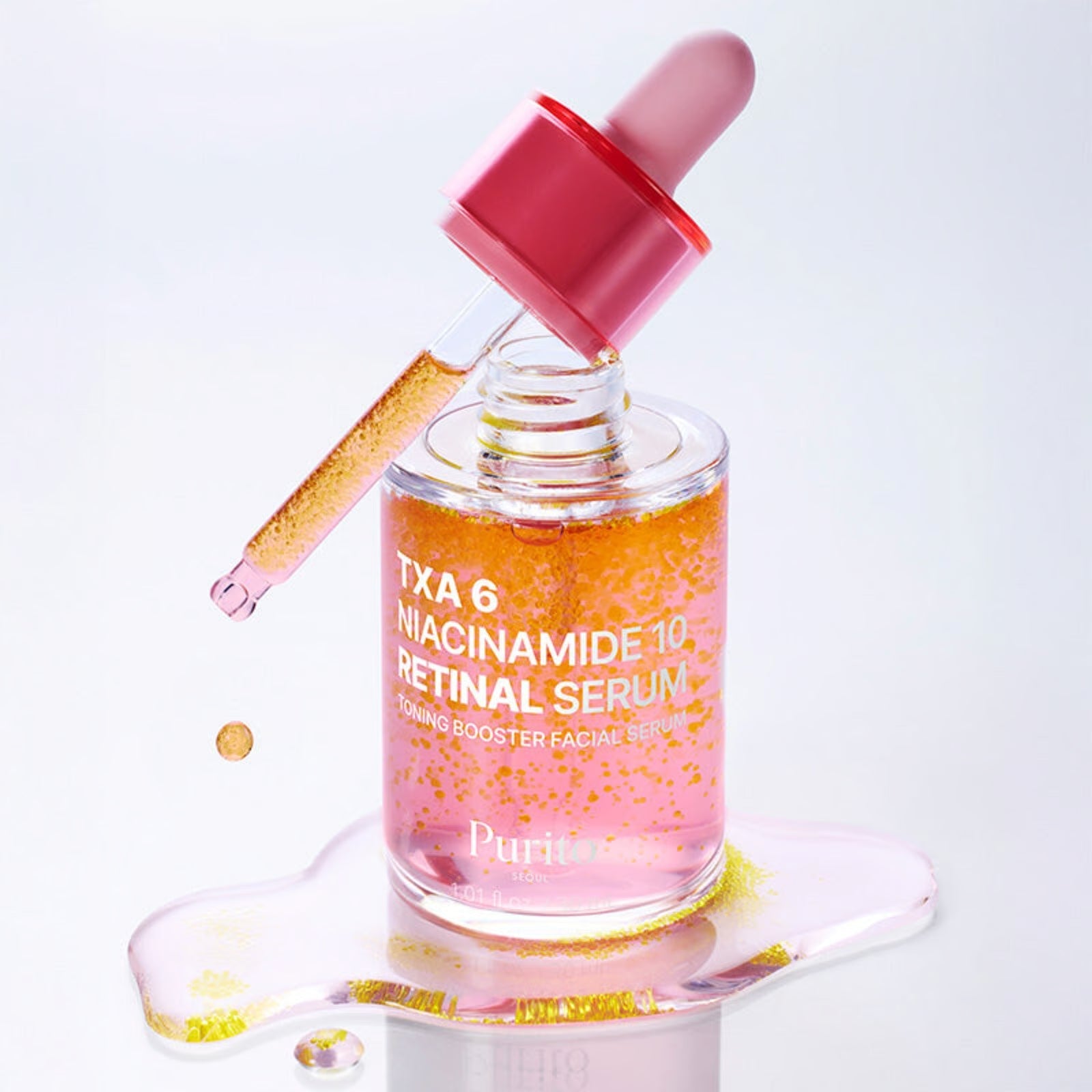 Purito TXA 6 Niacinamide 10 Retinal Serum bottle with pink liquid and yellow capsules.