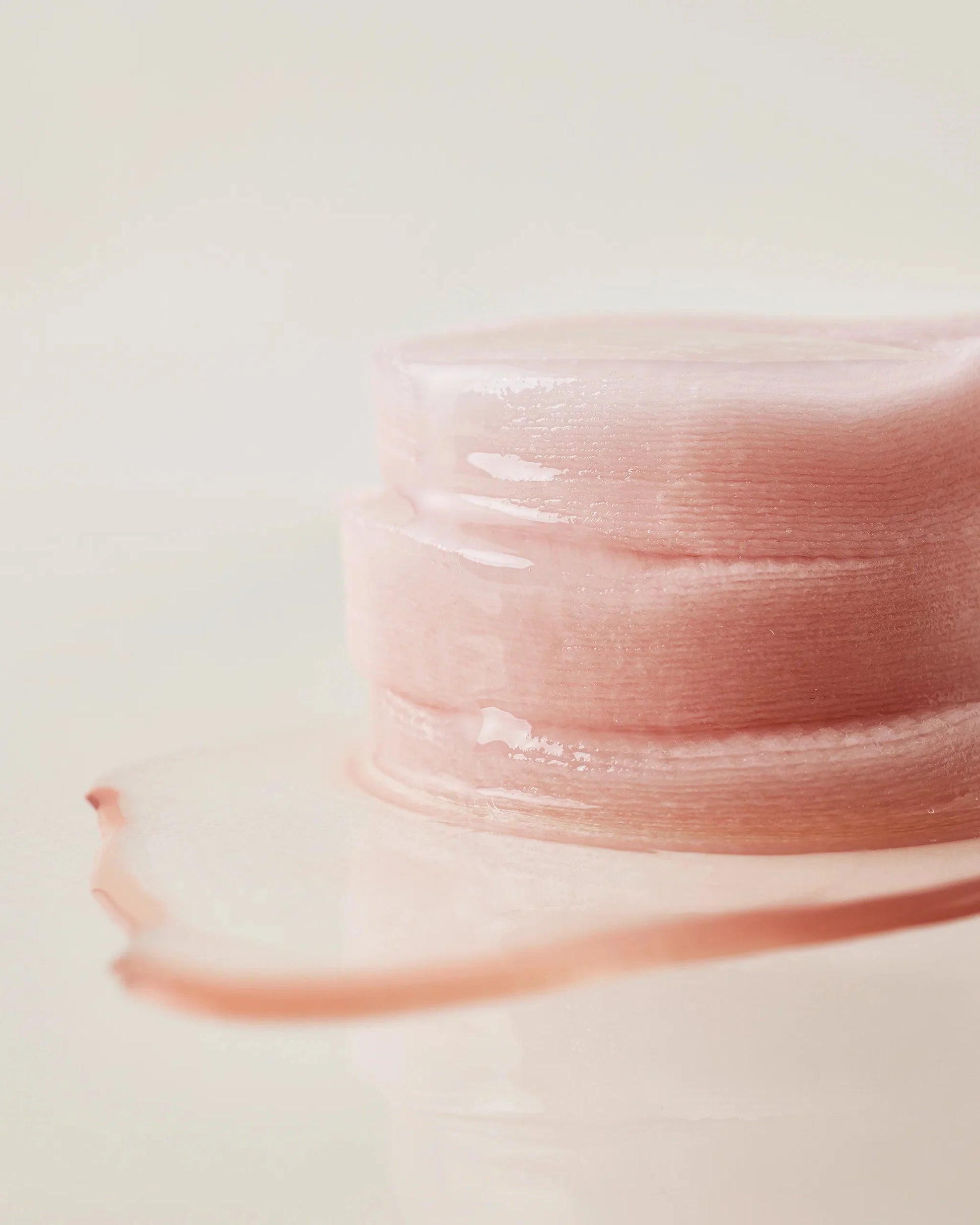 Close-up of a stack of moisture-soaked House of Hur essence pads.