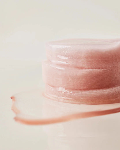 Close-up of a stack of moisture-soaked House of Hur essence pads.