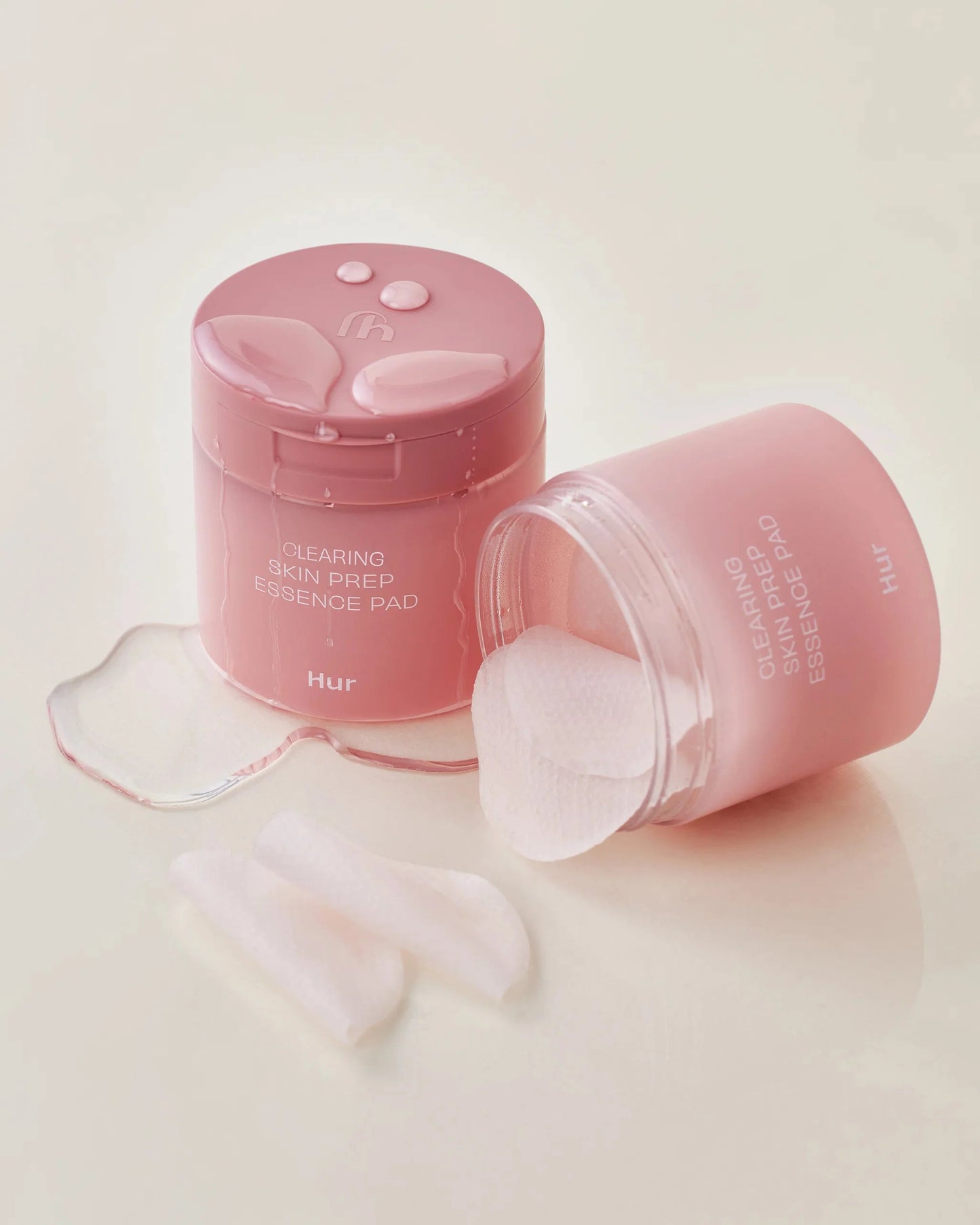 Pink jar of House of Hur Clearing Skin Prep Essence Pads with spilled essence.