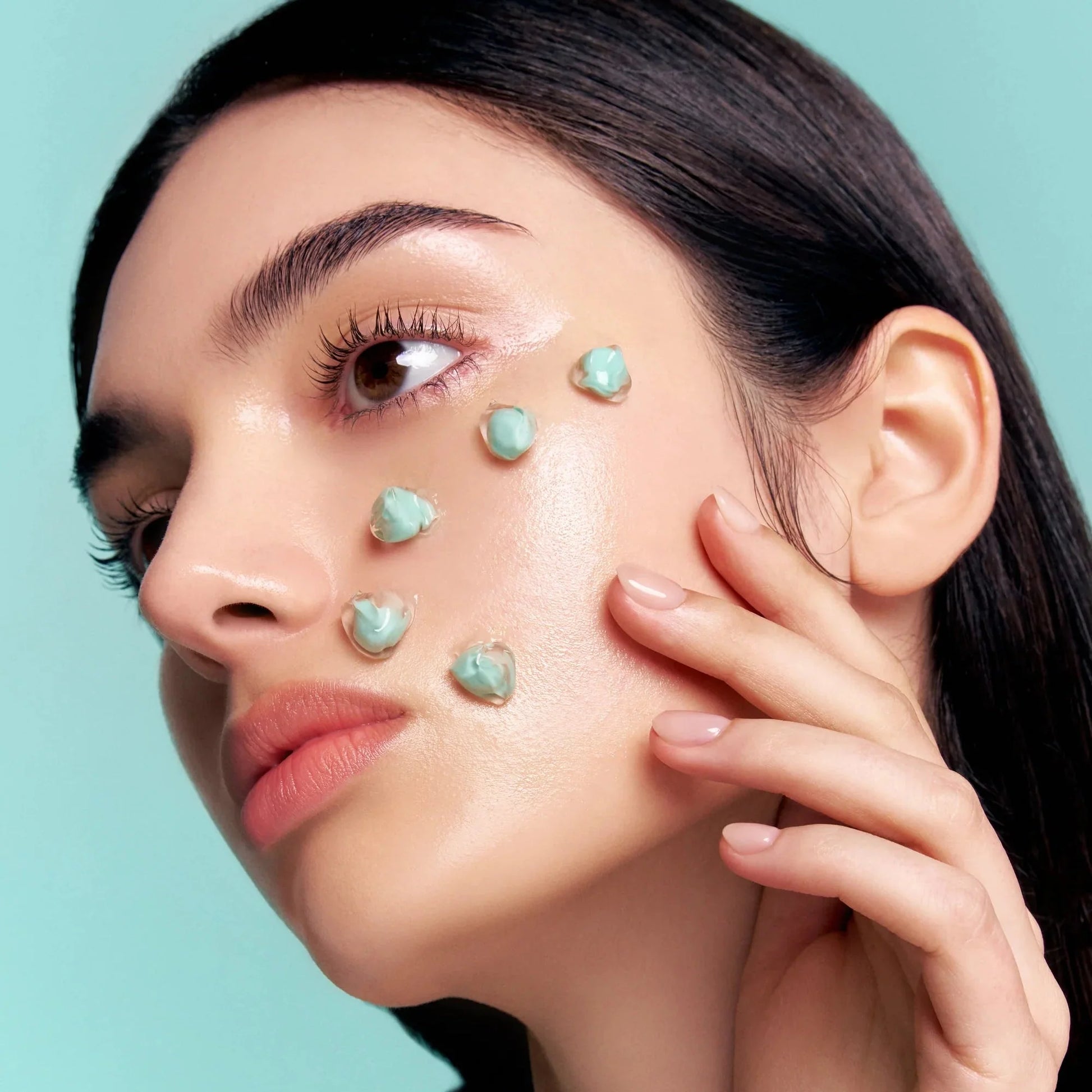 Model with glowing skin showing PDRN cream application on her face.